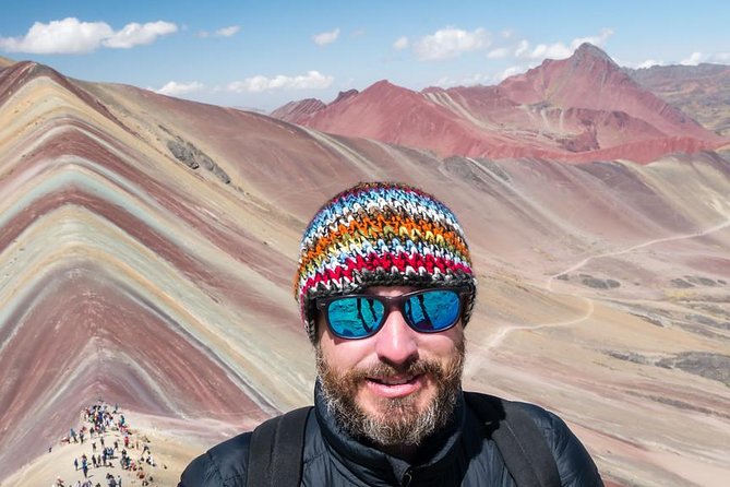 Rainbow Mountain Day Trip from Cusco: Vinicunca Hiking Tour - At the Top: Wind, Cloud Breaks, and Ausangate in the Distance